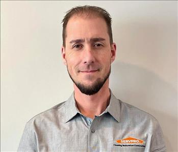 ServPro Employee in front of light gray back ground