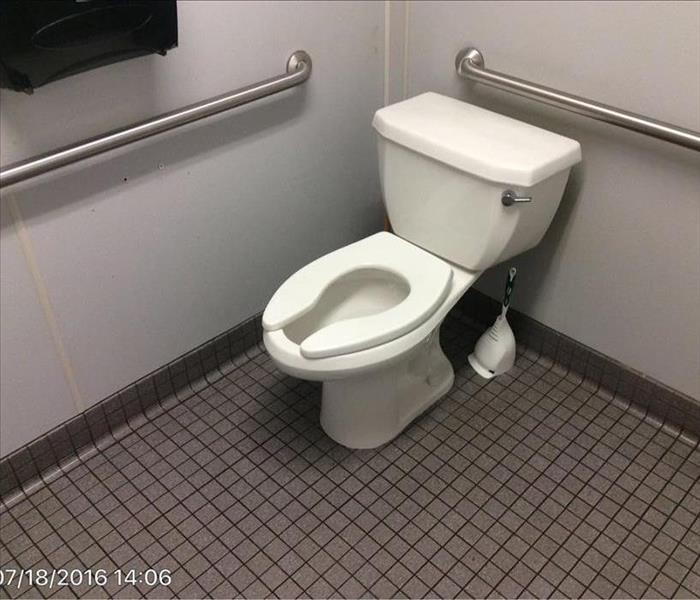 White toilet in gray bathroom