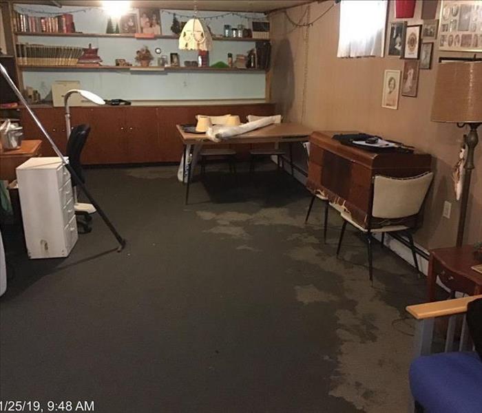 Dark Water on brown carpet with a desk and tables