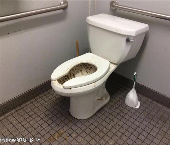 Feces, urine and toilet paper toilet walls, and floor in bathroom