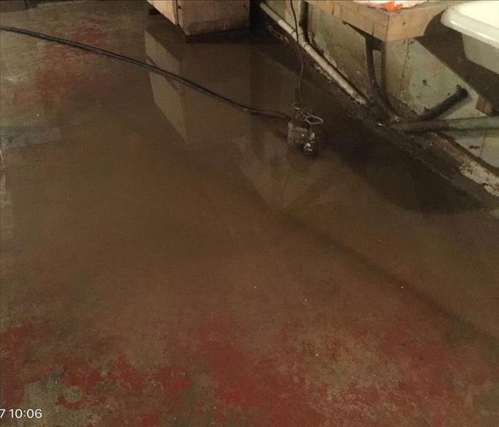 Brown water on red and gray basement floor