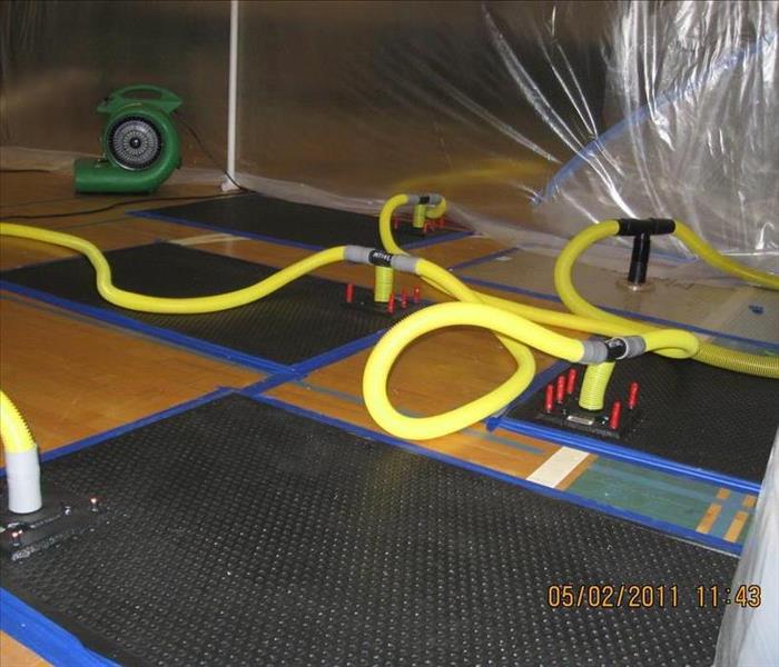 Floor mat drying system on a gym floor after a water damage