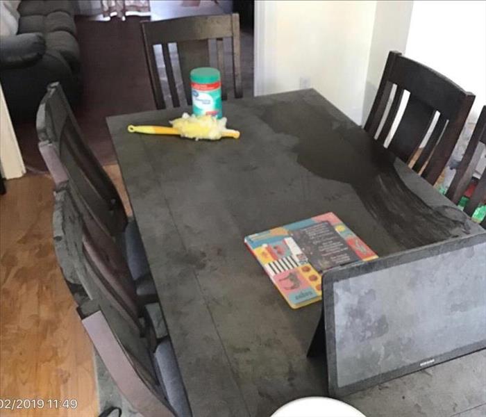 Dark brown dining set and Ipad covered with soot